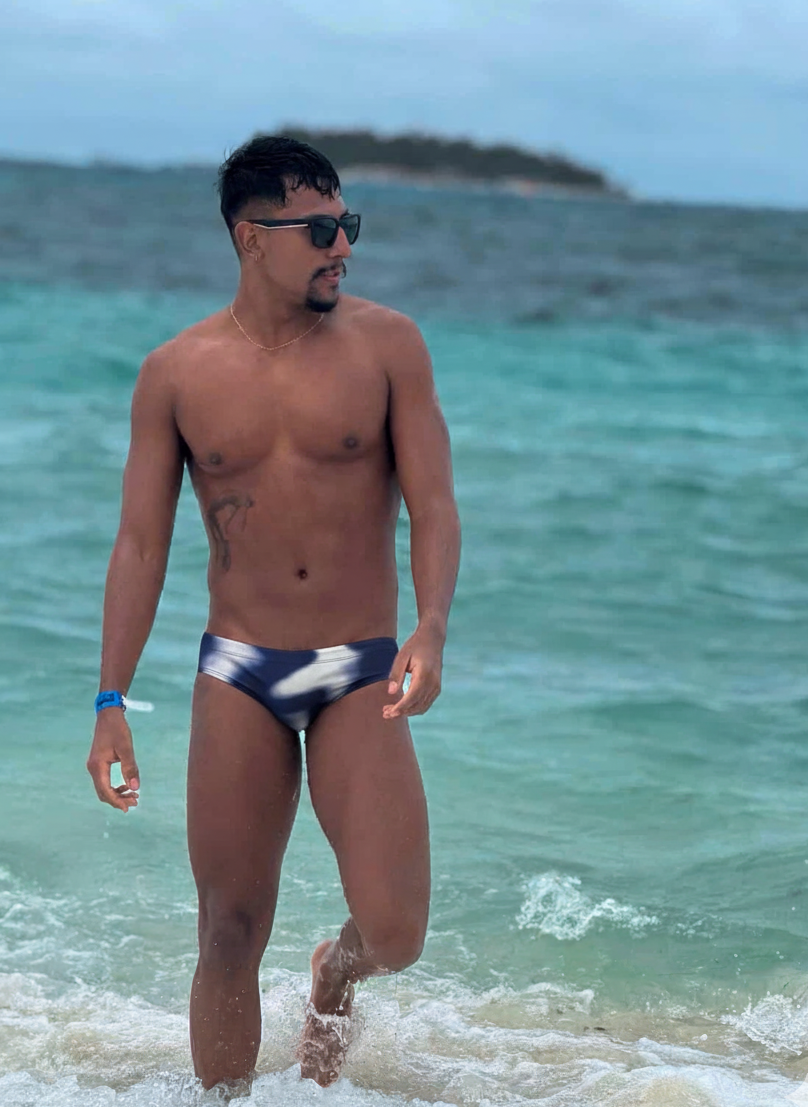 Man walking on a beach with ocean in the background
